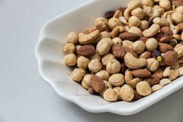 nuts, peeled hazelnuts, cashews and almonds, stand together,