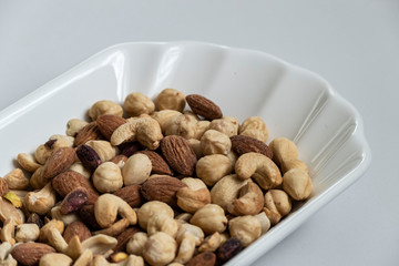 a plate full of nuts, cashews, almonds dry, close-up