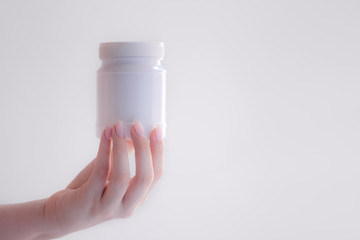 white medicine container, bottle for pills, medicine, vitamin package, pocket first aid kit.