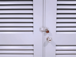 Full Frame Front View of White Wooden Locked Door with Ventilation Grilles