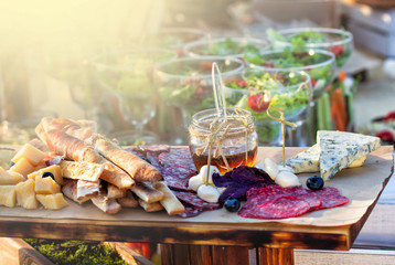 catering table set service with silverware and glass stemware at restaurant before party