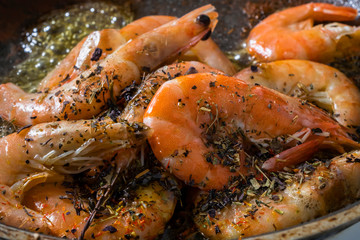 Shrimps are fried in a pan with spices and olive oil
