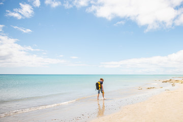 Fototapeta na wymiar lonenly traveler walks costa calma beach in fuerteventura 