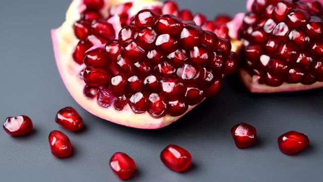 Rotating india pomegranate Seeds on black background in 4K resolution