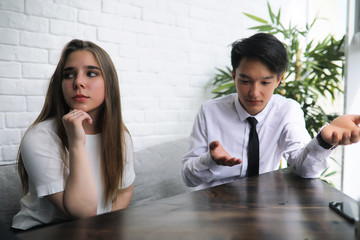 A pair of young people talking at the office