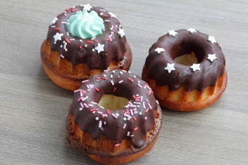 Chocolate coated cakes with decorative topping. Located in the shape of a triangle.