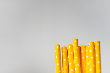 Yellow paper straws isolated on white background