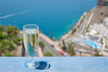 The glass of wine against the picturesque sea view illustrating the holiday and relax atmosphere.