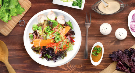 Rabbit meat salad, ingreadients and props on a wooden table. Top view