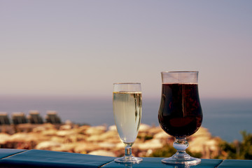 Two glasses of wine on the balcony of the luxurious hotel, illustrating wonderful vacations.