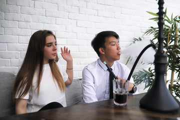 A pair of young people talking at the office