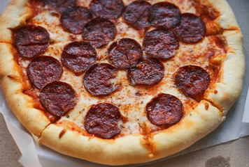 Hot pepperoni pizza in a market box close-up
