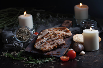 Black pepper steak and ingredients and herbs on the wooden table. Shooting in  in low key .
