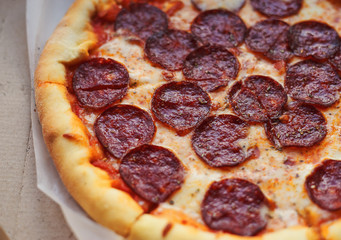 Hot pepperoni pizza from delivery in box close-up