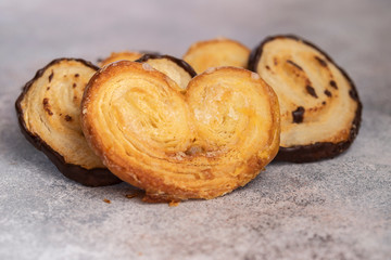Cinnamon and chocolate Elephant Ears cookies on the table. Palmiers pastry background.