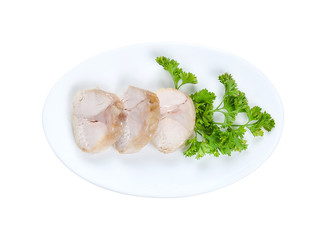 Cooked slices of rabbit meat isolated on white background on white plate with parsley,. Top view. With clipping path