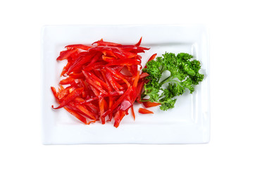 Plate of sliced red and green pepper isolated on white. Top view. With clipping path