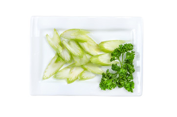 Sliced celery in a plate isolated on white background. Top view. With clipping path