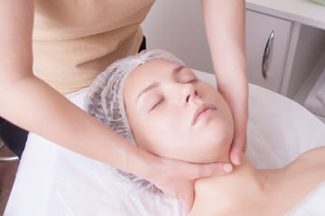 Fototapeta na wymiar Closeup of young woman receiving neck massage from massage therapist.