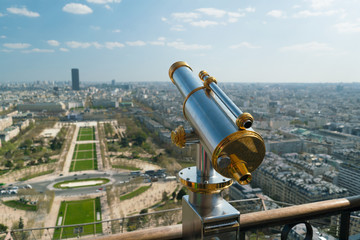 Monocle or tourist telescope on the observation deck with cityscape