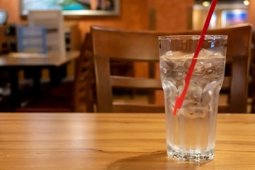 Glass water drink with tube on table
