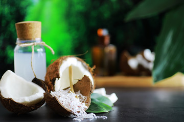 Coconut on a dark stone table. Coconut oil.