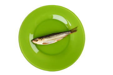 Cold smoked Baltic herring on an green plate isolated on white background.
