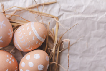 Close up Easter eggs in nest on paper background with copy space.Top view.flat lay.