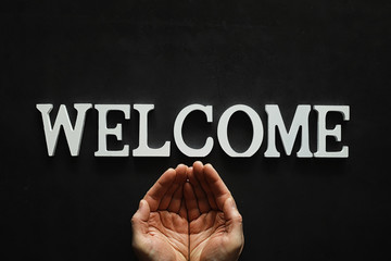 Background concept. Inscription Welcome on a dark background.