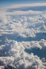 Fototapeta na wymiar Fluffy white clouds, a view from airplane window