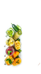 Variety of fruit infused detox water in jars for a healthy diet eating and weight loss. healthy...