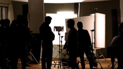 Shooting studio behind the scenes in silhouette images which film crew team working for filming...