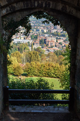 Fototapeta na wymiar View of Bergamo through the arch of Rocca di Bergamo fortress in Upper Town Citta Alta. Italy