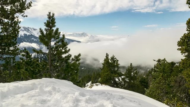 Timelapse of a cloud sea with snowy mountains.