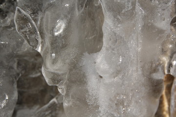 Icicles hanging on a ledge with rocky bacground