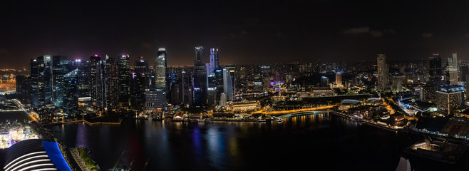 Fototapeta na wymiar Singapore - January 2019: Aerial night panorama of a Singapore's business district and Marina Bay