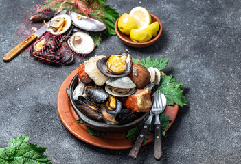 Famous traditional dish of the south of Chile and the Chiloe archipelago - Curanto al Hoyo, Kuranto.  Different seafood,  meat and potatoes milcao cooked in a pit on the coals under the ground