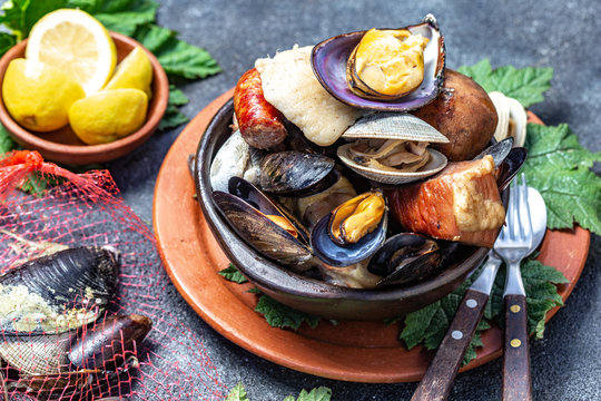 Famous traditional dish of the south of Chile and the Chiloe archipelago - Curanto al Hoyo, Kuranto.  Different seafood,  meat and potatoes milcao cooked in a pit on the coals under the ground