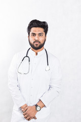 Handsome young doctor in a white coat with a stethoscope. Health care concept.