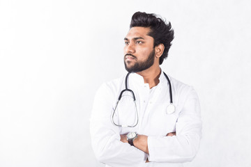 Fototapeta premium Handsome young doctor in a white coat with a stethoscope. Health care concept.