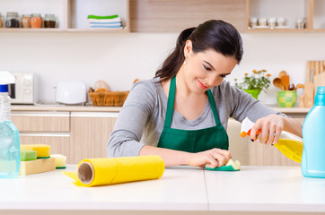 Young female contractor doing housework 