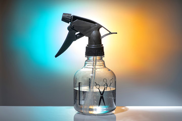 Spray bottle for hairdresser, transparent bottle with black nozzle, close-up