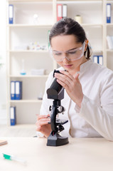 Young female chemist working in the lab 