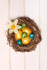 Easter eggs on wooden background. Top view with copy space.