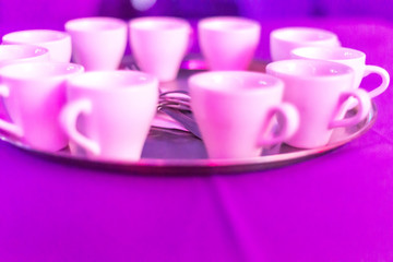 small coffee cups on round metal plate 