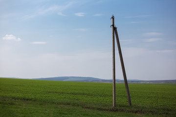 Fototapeta na wymiar Stone electric pole in agriculture field.