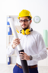Young male architect working in the office 