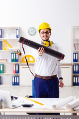 Young male architect working in the office 