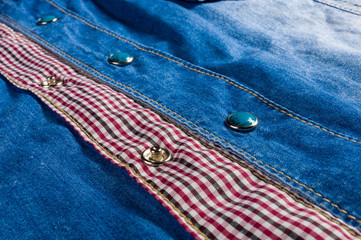 Blue washed faded jeans texture with seams, clasps, buttons and rivets