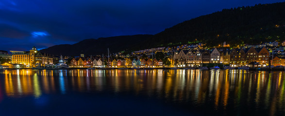 Fototapeta na wymiar Wide night cityscape of the iconic Bergen harbour ad Bryggen historic district, Norway